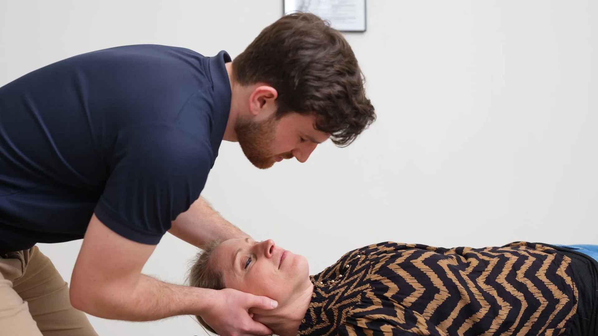 Chiropractor voert nekcorrectie uit op patient op behandeltafel bij Waterland Chiropractie Culemborg